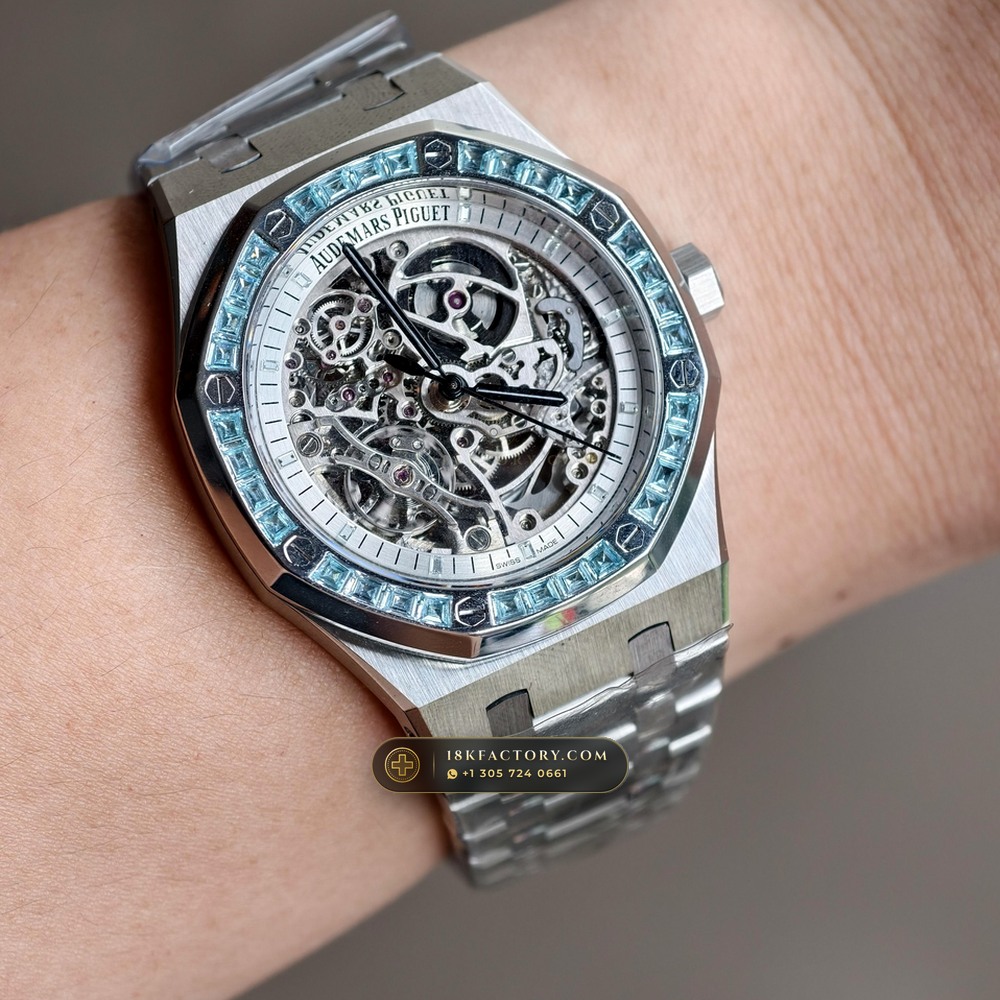 Audemars Piguet Royal Oak Double Balance Wheel Openworked 41mm Baguette Blue Topaz Bezel 18K White Gold Ref. 15412BC.TO.1220BC.01 — XRF Certified Edition — Studio Angle 19 in 18K White Gold Au750 (224.8g Verified Mass, Audemars Piguet Cal. 3132 Dual-Balance Openworked)